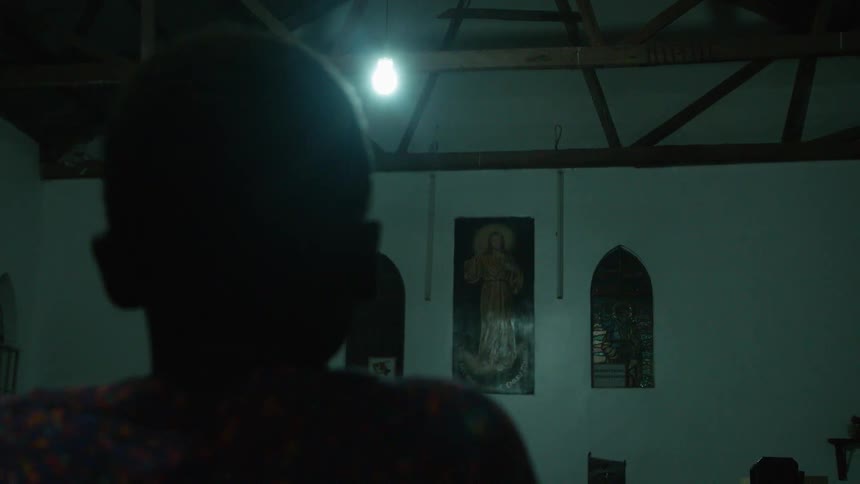 A boy stares at a church painting
