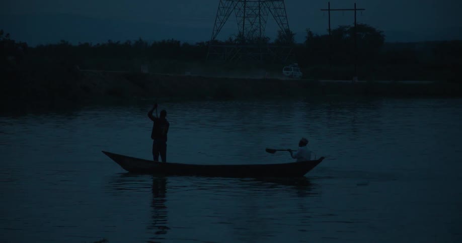 Two people steer a kayak