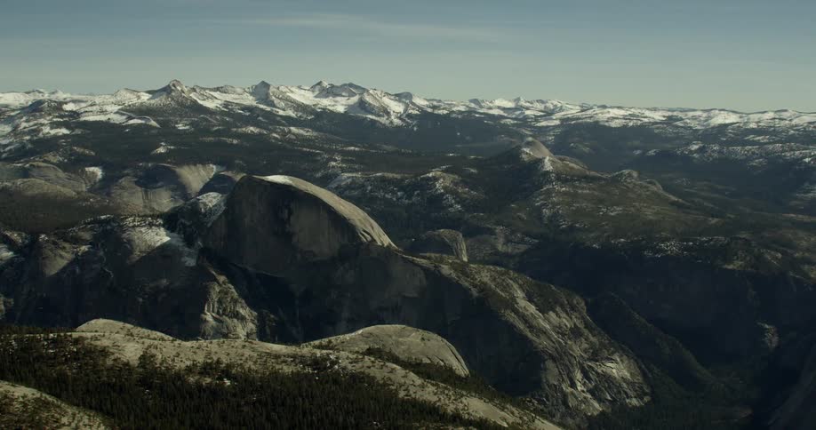 Mountainous area with some snow-covered and some not near Half Dome in Yosemite National Park, California