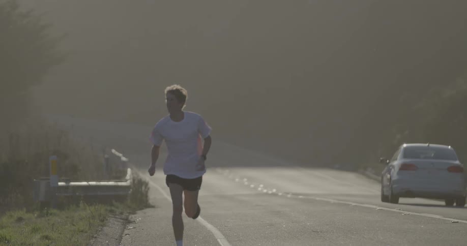 A man jogs down a rural road