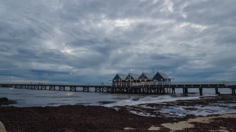 cloudy sunrise on the coast with pier