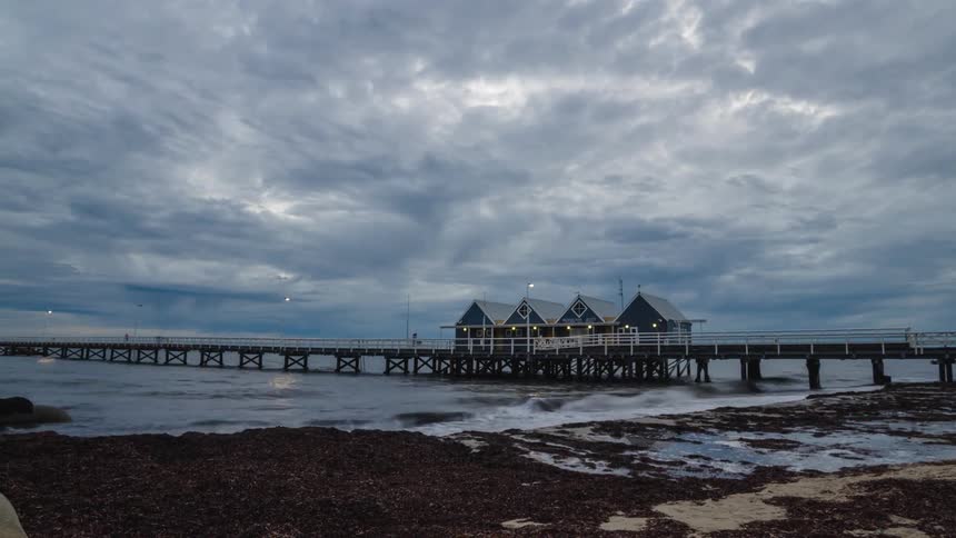 cloudy sunrise on the coast with pier