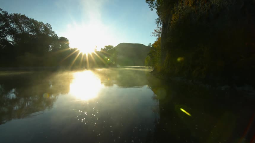 The sun rays reflect off of a river