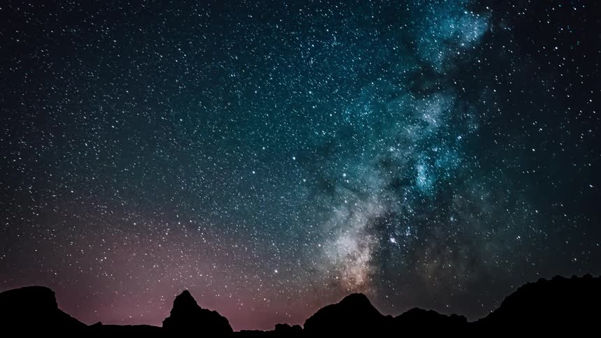 Stars over jagged mountains