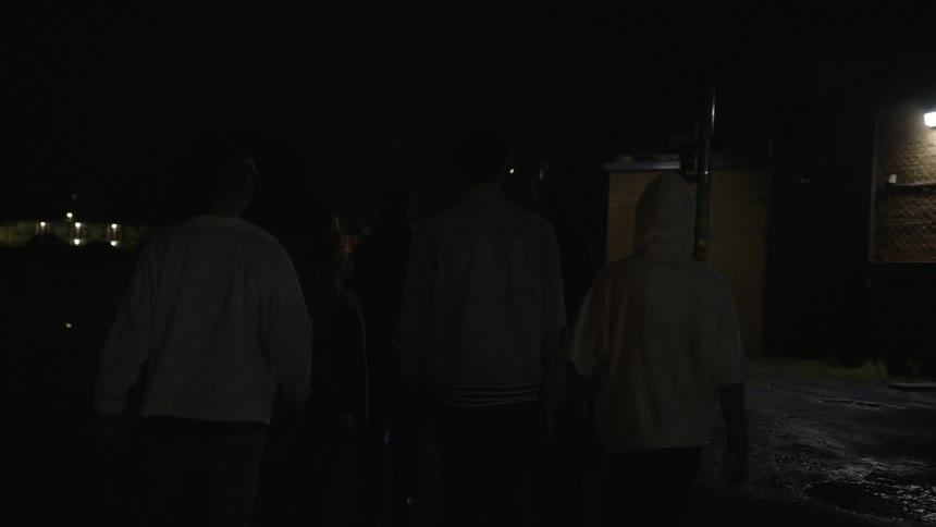 People walking down a dark street