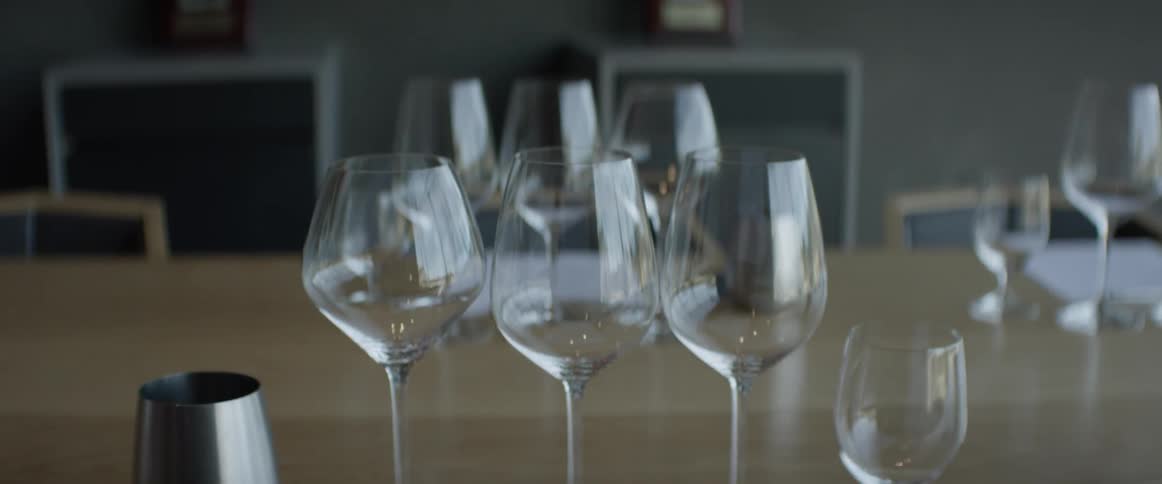 A variety of wine glasses sit empty and waiting on a table