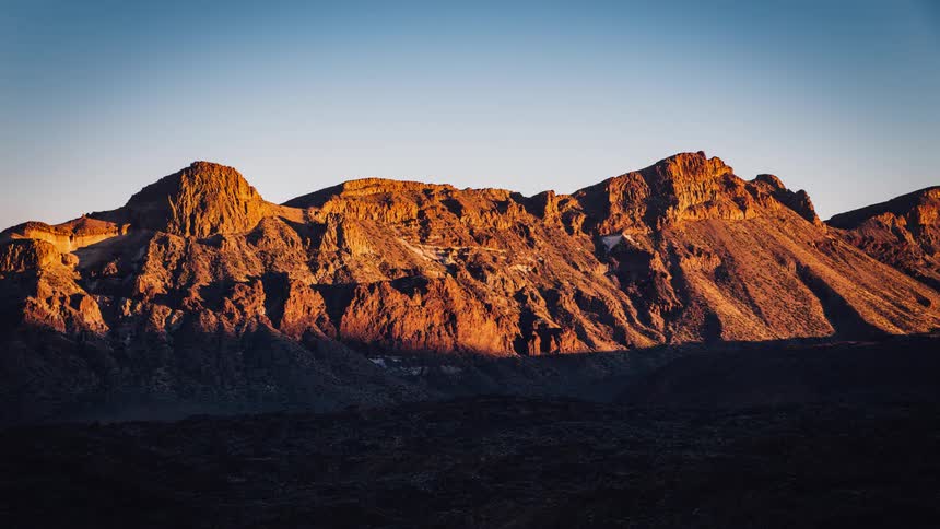 Mountains are gradually covered by a large shadow