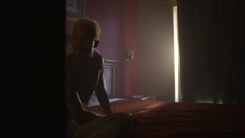 A man sits on the bed