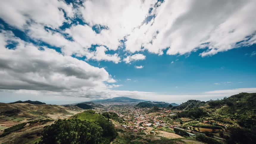 Clouds pass by above a mountain town