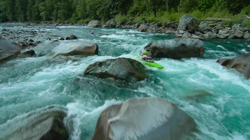 A person is rowing down the rapids