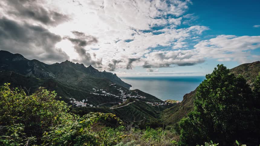 Mountains sit under a cloudy sky
