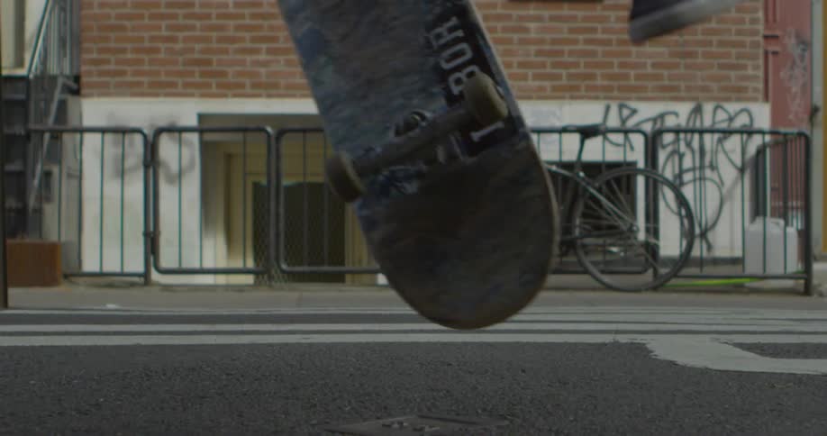 Someone is doing skateboard tricks on a street