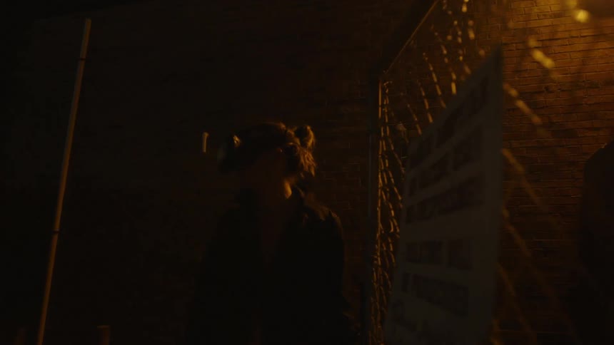 A man stands outside a fence with vr glasses on
