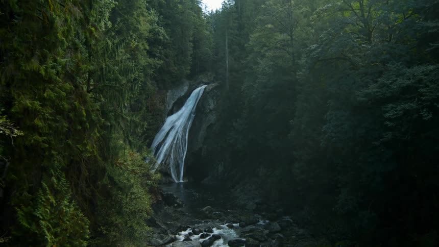Water flows down a mountain to a lake below