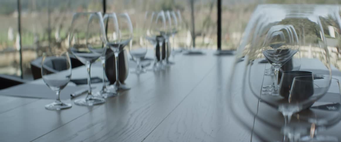 An empty dinner table is set up for guests