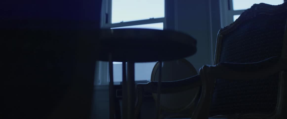 Chairs and a round table sit near a window