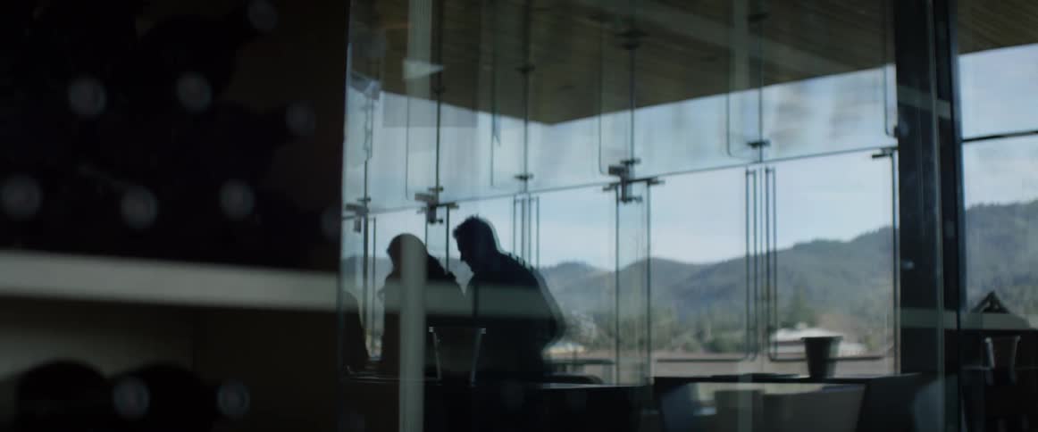 The reflection of some people are being seen in a window