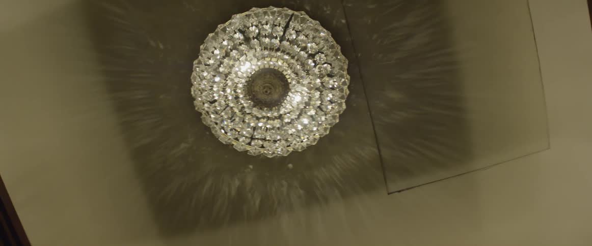 A chandelier shines on the ceiling