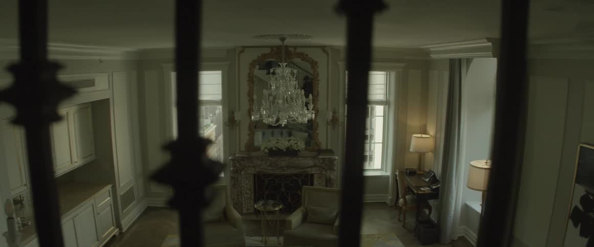 A large chandelier hangs downstairs