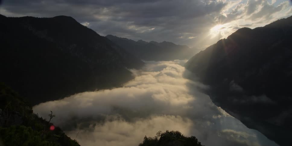 A foggy river between mountains