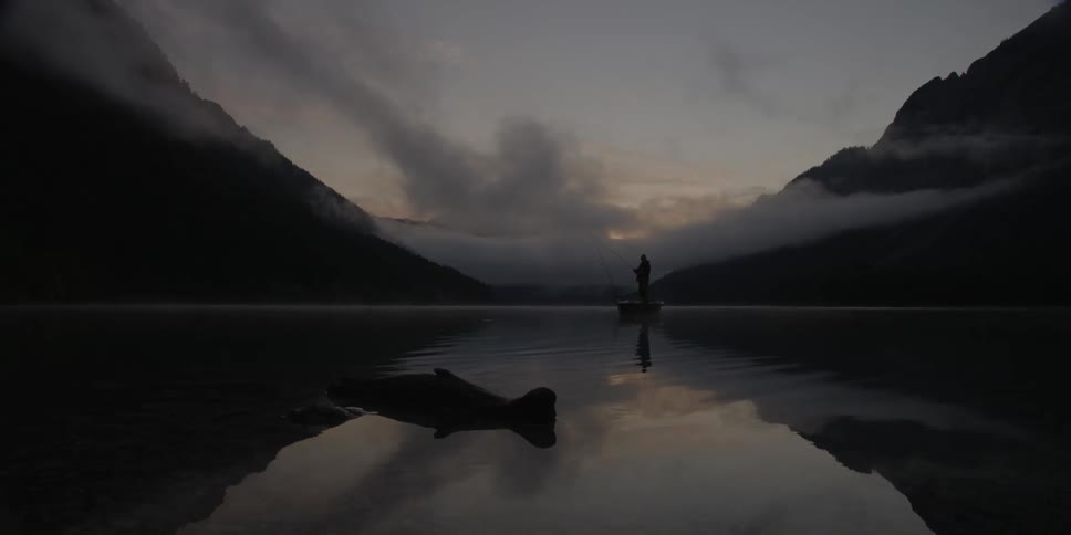 Someone is standing on a small boat fishing