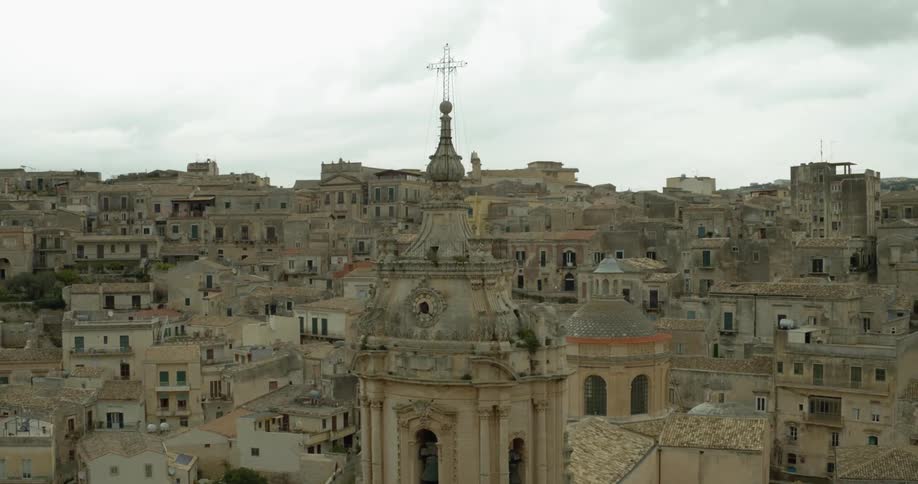 A cross sits atop a tall building