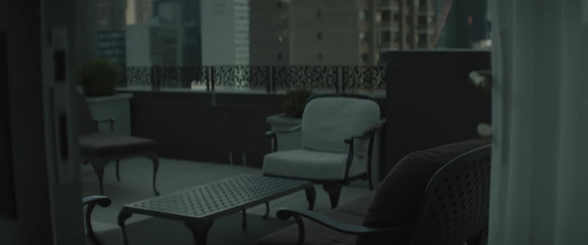 A rooftop balcony in a city sits empty