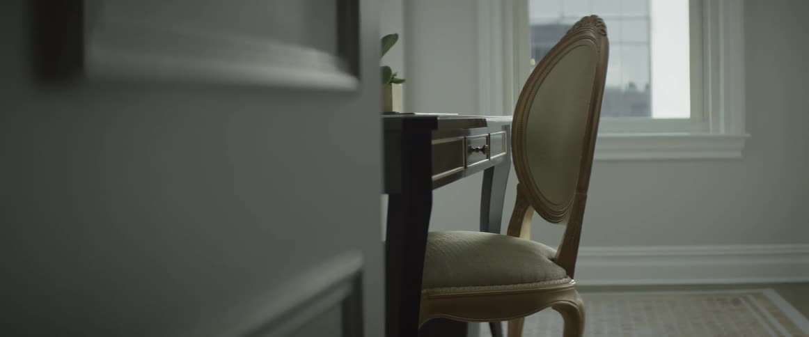A white chair at a small desk