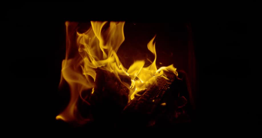 Flames burn on logs in a fireplace or stove