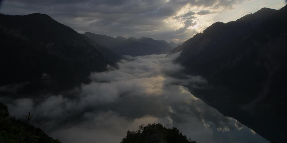 Fog over a river between mountains