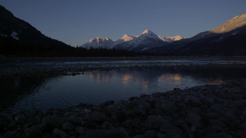A lake and mountain range in the background