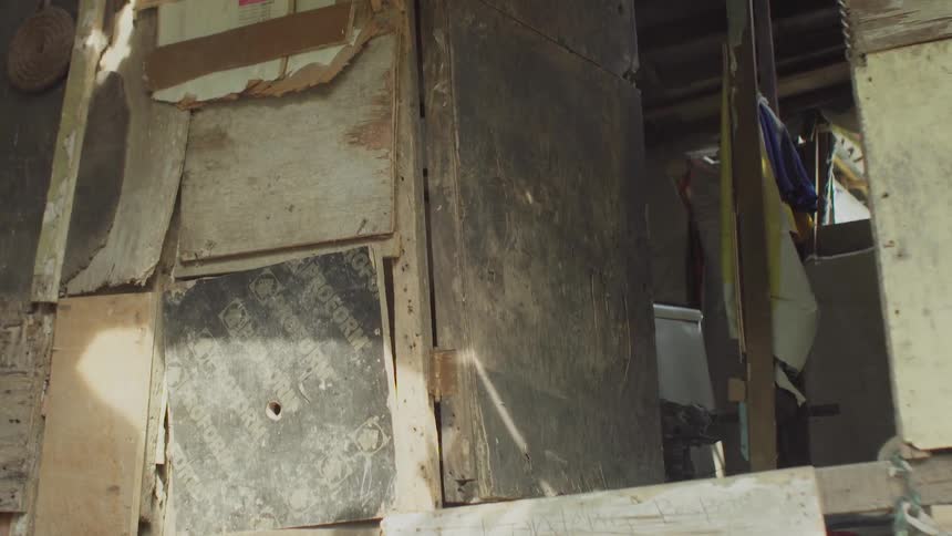 A dilapidated building is being filmed from inside
