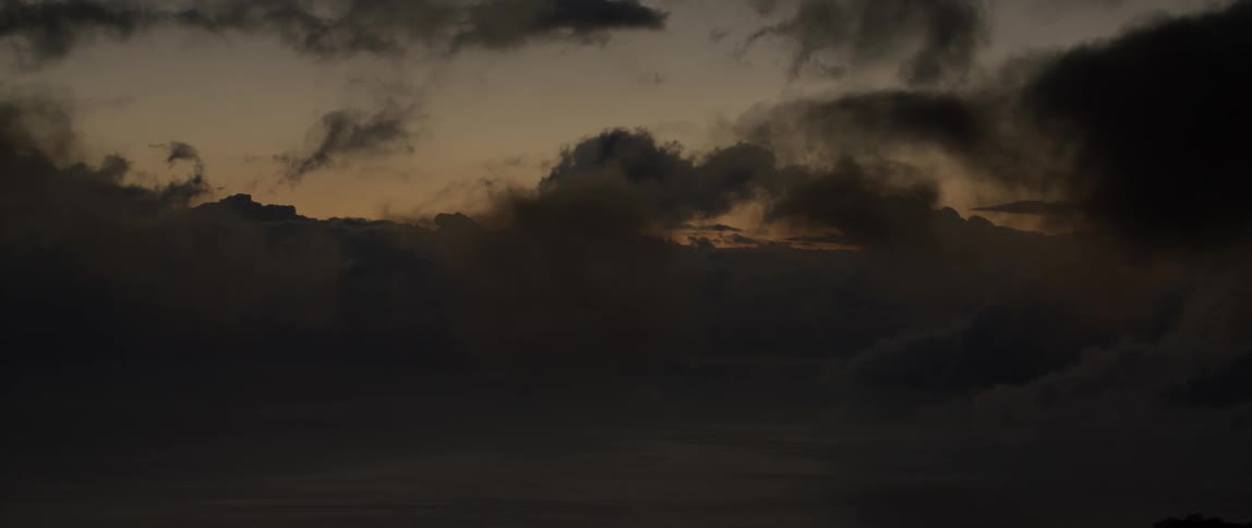 Clouds are being filmed from the air at sunset