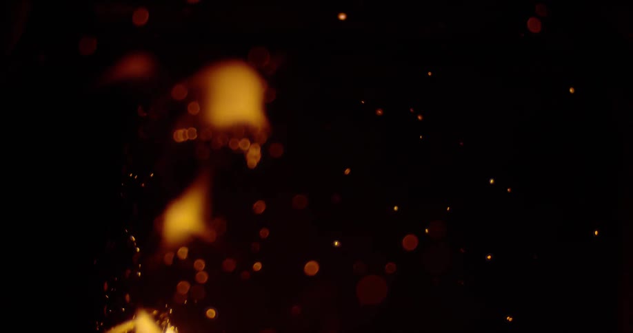 Flames are casting sparks into the darkness