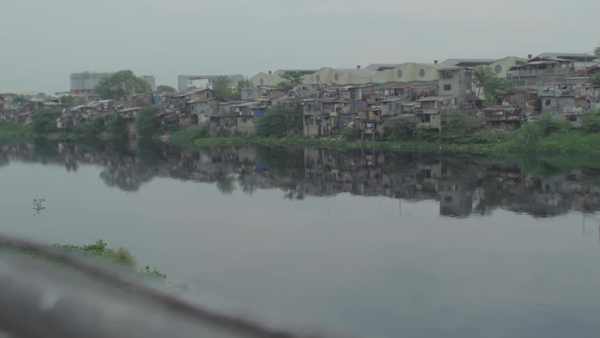 A shanty village is set up on the waterline