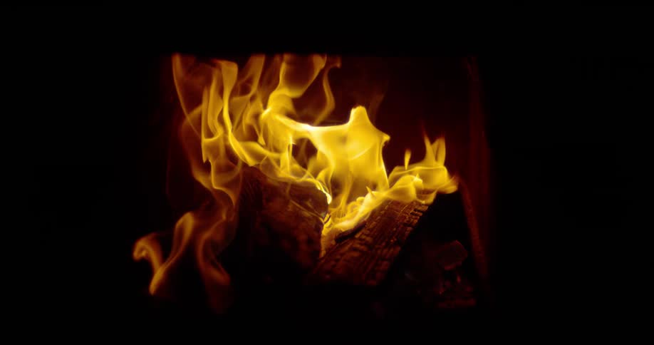 A fire burns in the dark ahead