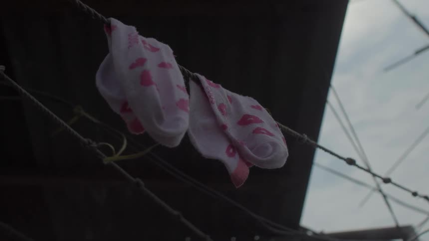 Pink socks hang from a clothesline