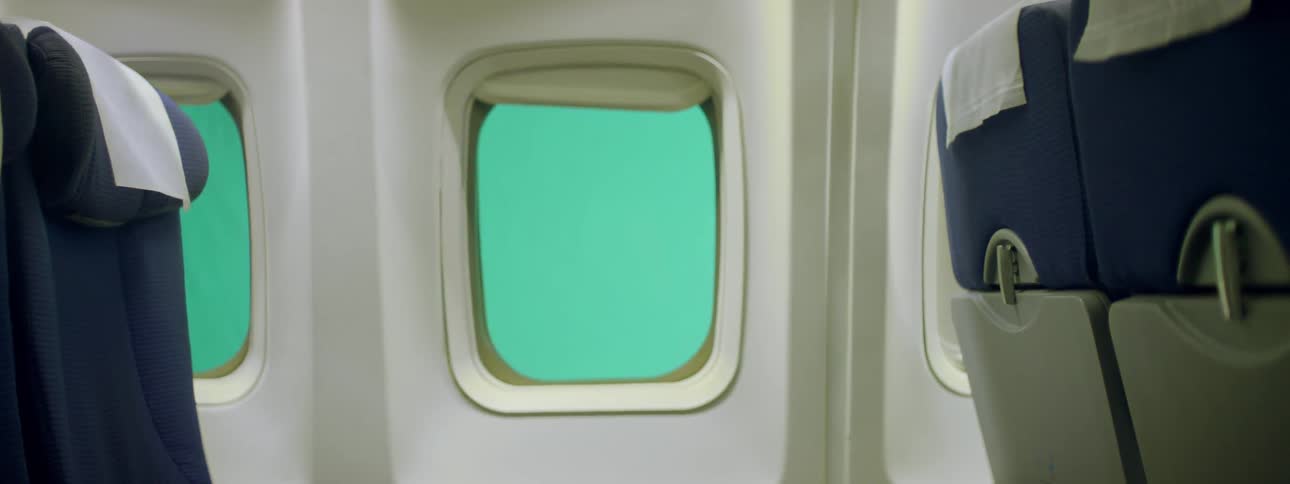 A plane window shade sits open