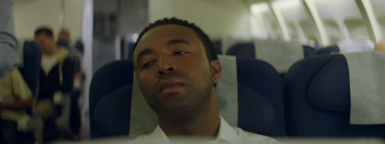 A man closes his eyes on a flight