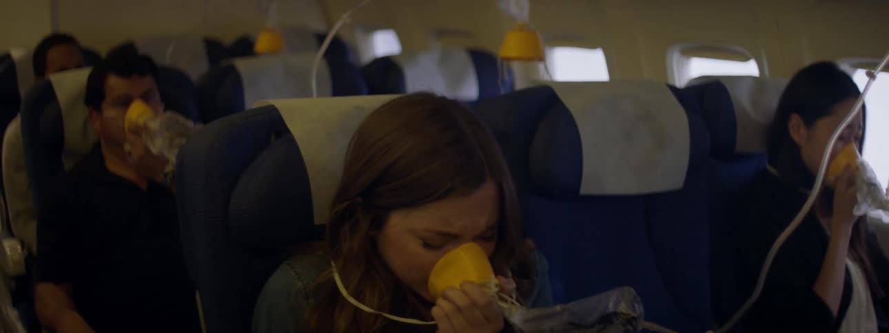 Plane passengers wearing oxygen masks