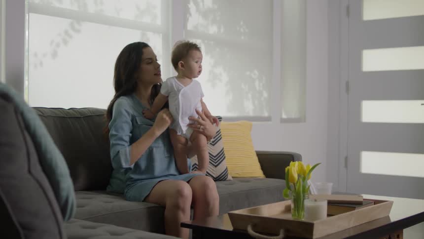 A woman holds a baby on her lap