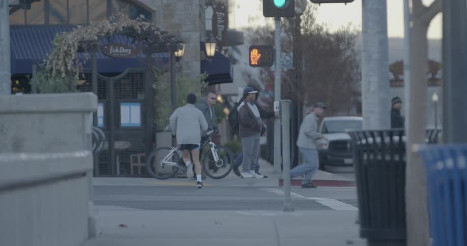 A man is jogging through a street