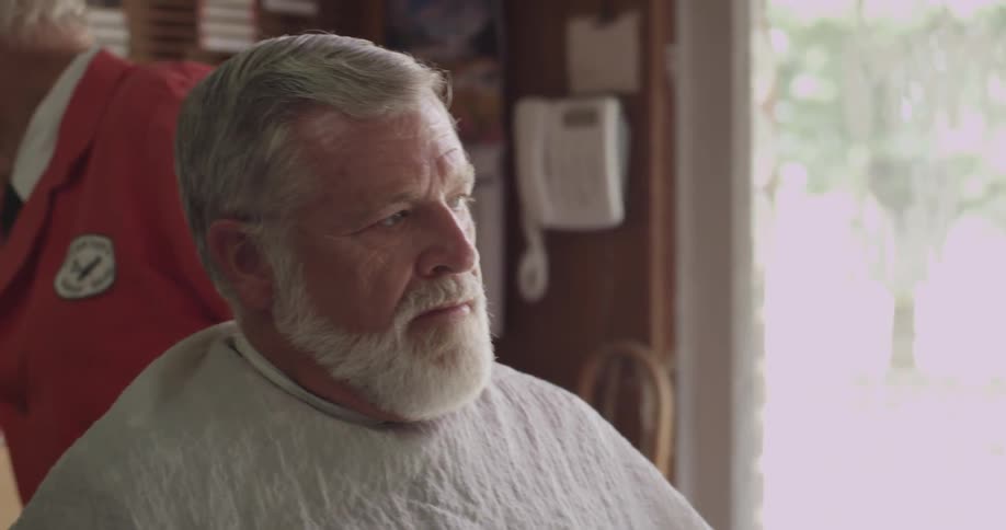 A barber speaks to his customer