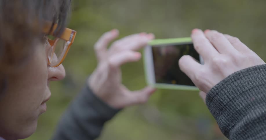 A person takes a picture with a phone