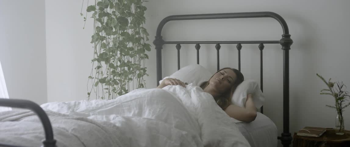 A woman is sleeping in bed