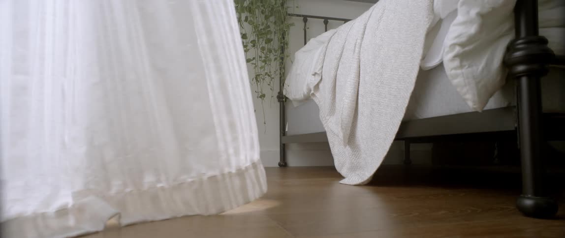 White curtains blow in a gentle breeze
