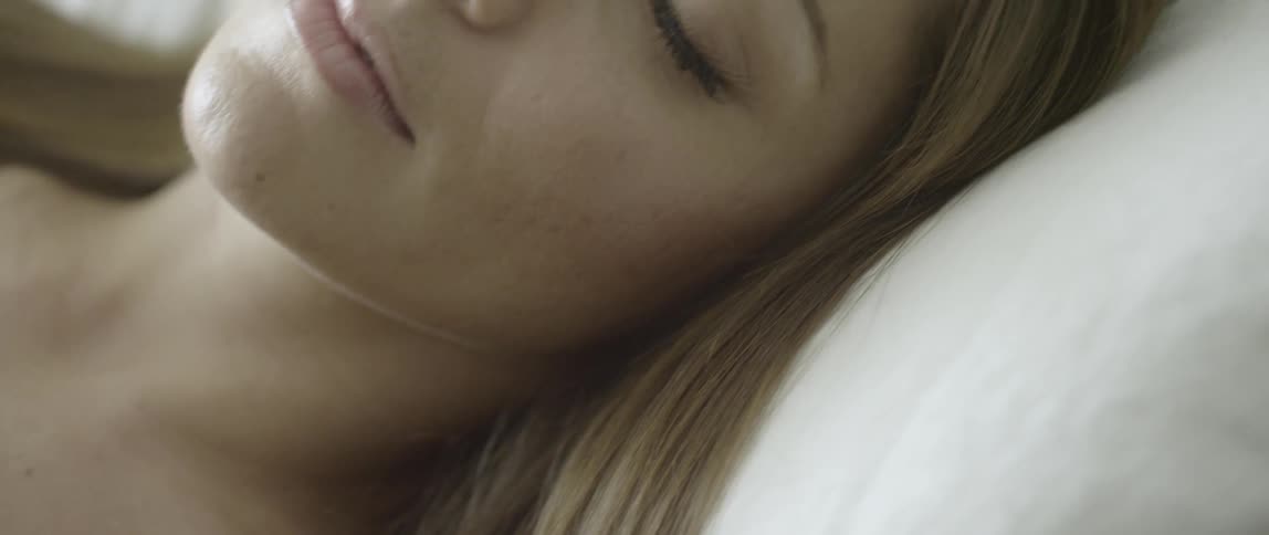 A woman is sleeping in bed