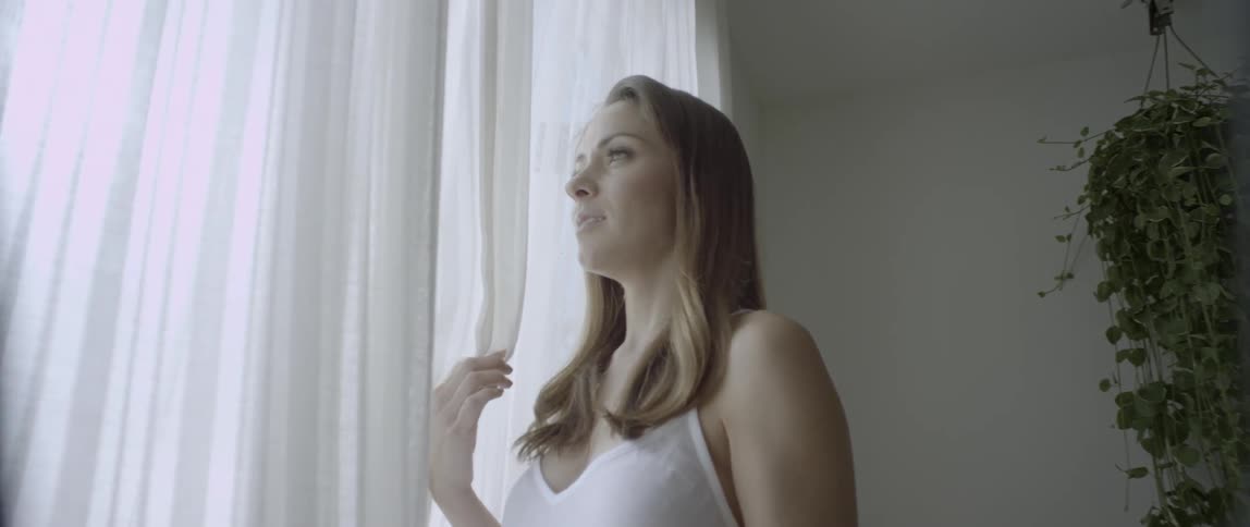 A woman stands at the window