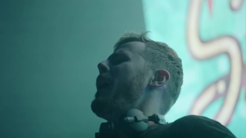 A dj dances and yells while he performs