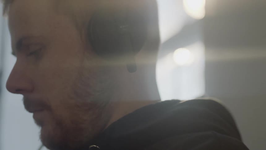 Bearded man wears a set of headphones